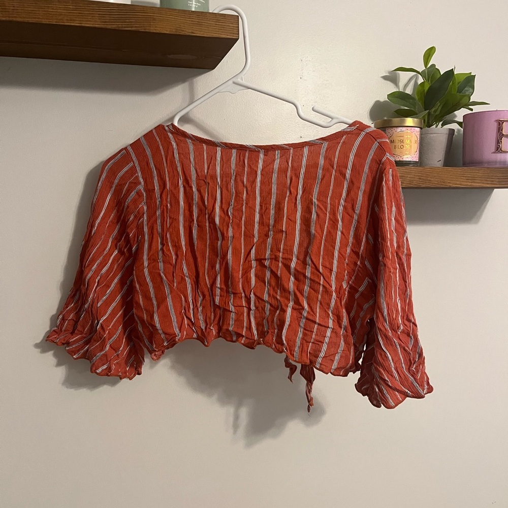 cute tie top with a orangish-red color to it